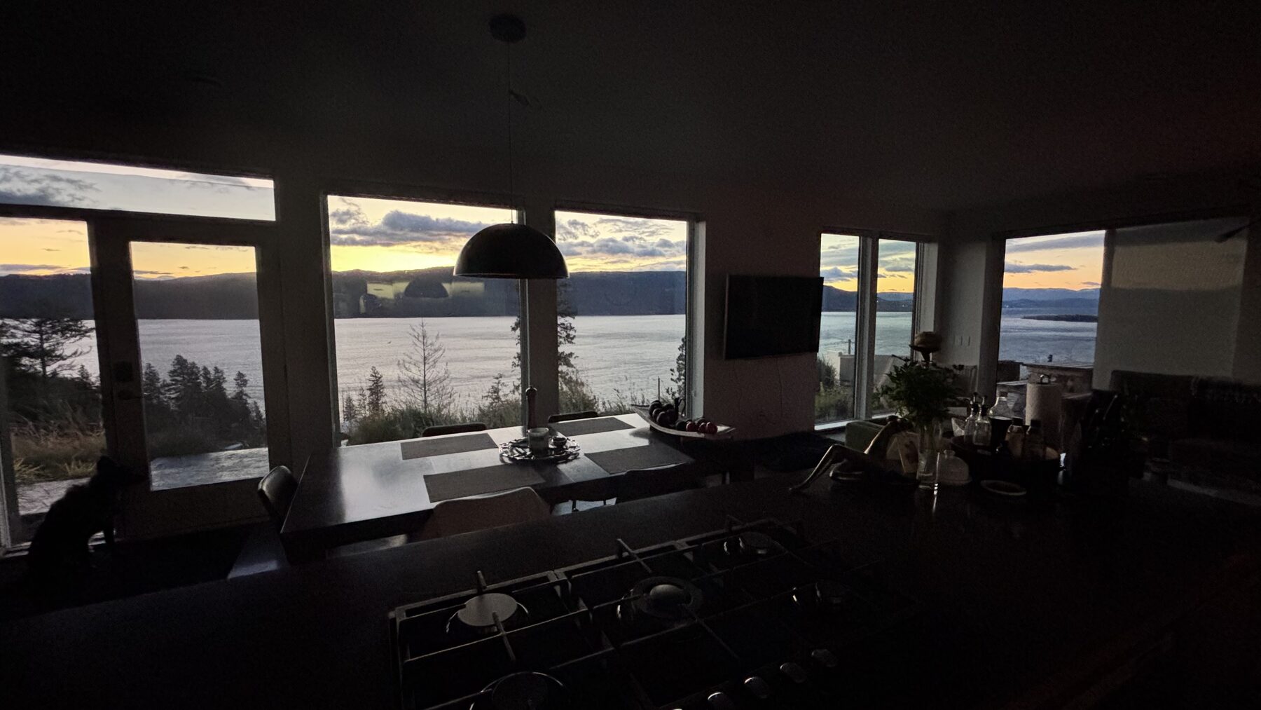 Dining and kitchen area at sunset with lake views