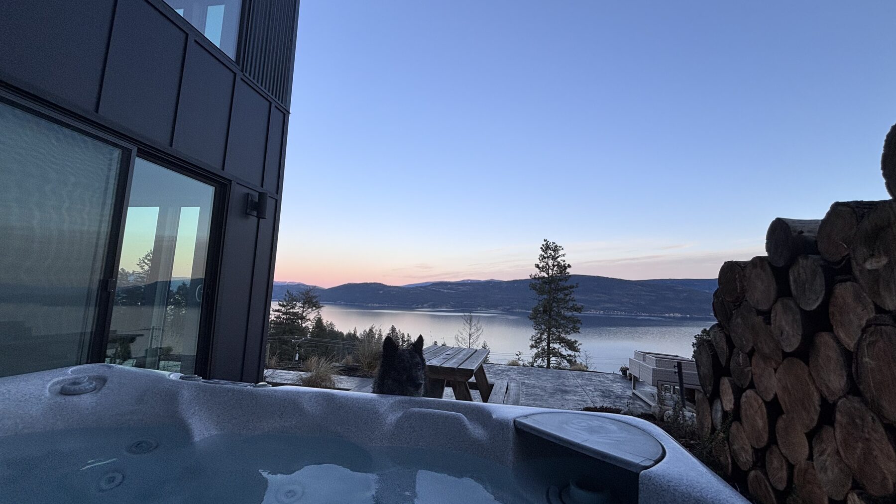 Hot tub on the deck at dusk overlooking the lake