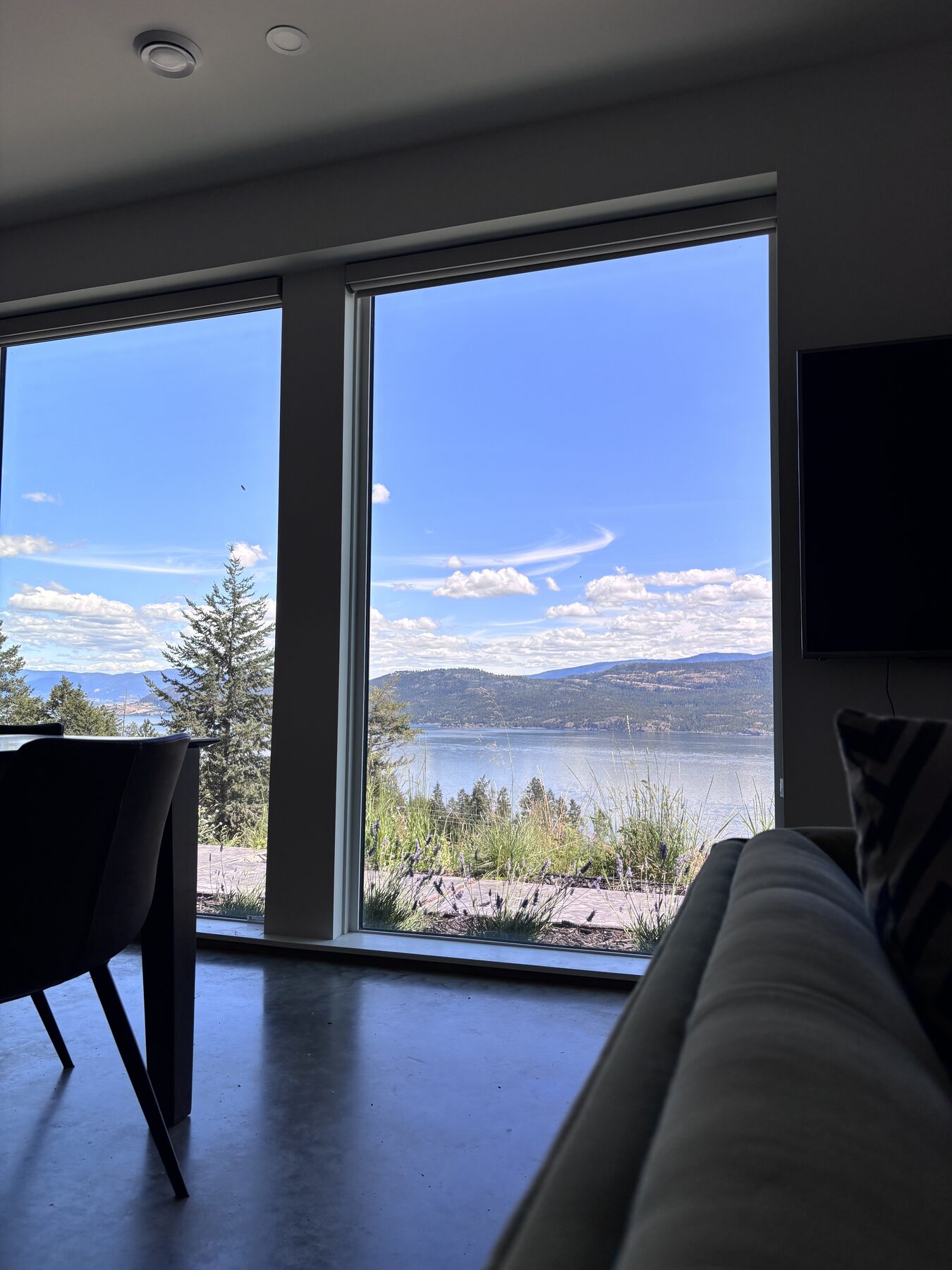 Living room corner with floor-to-ceiling windows over the lake