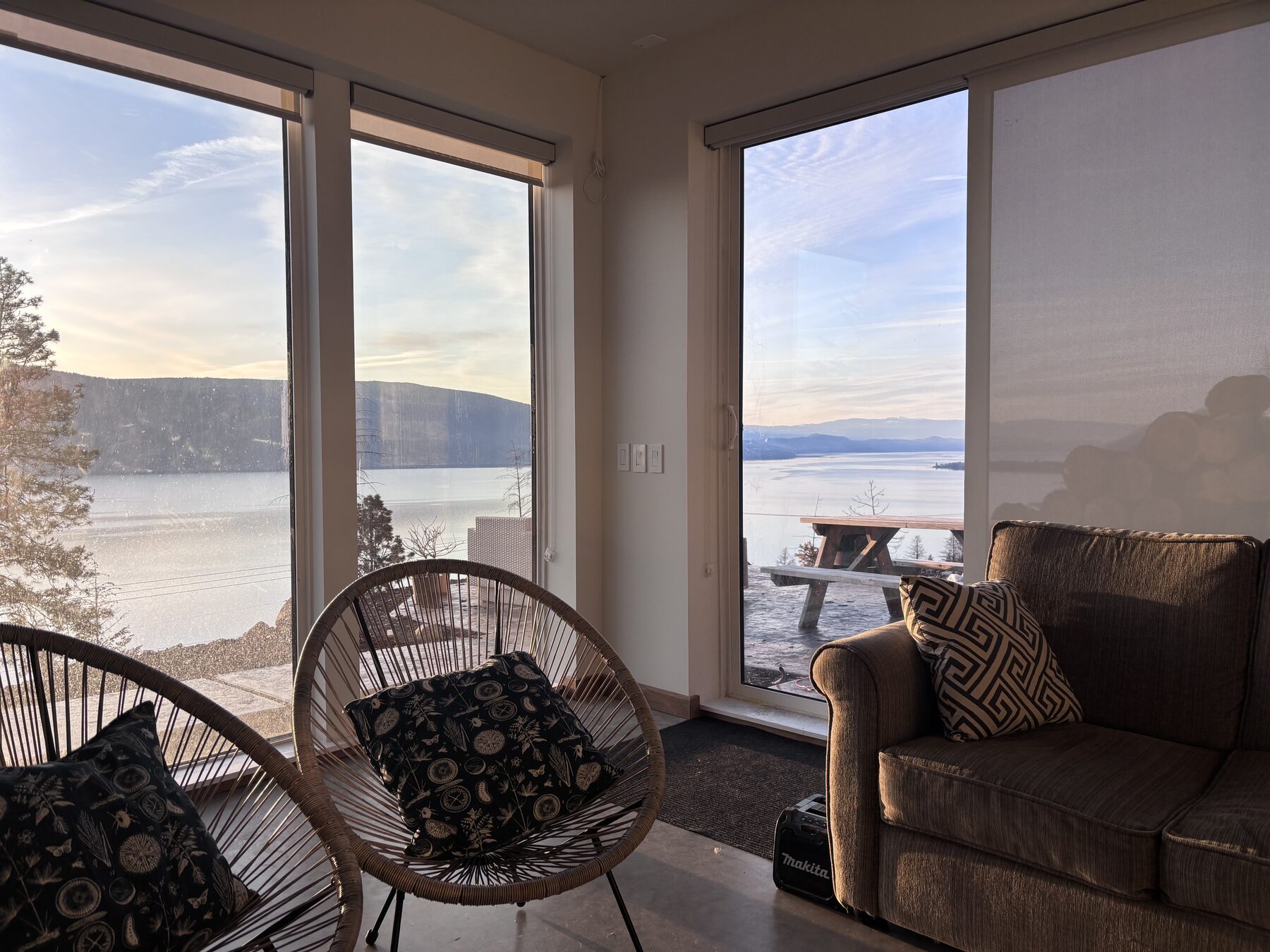 Reading nook with woven chairs facing the lake